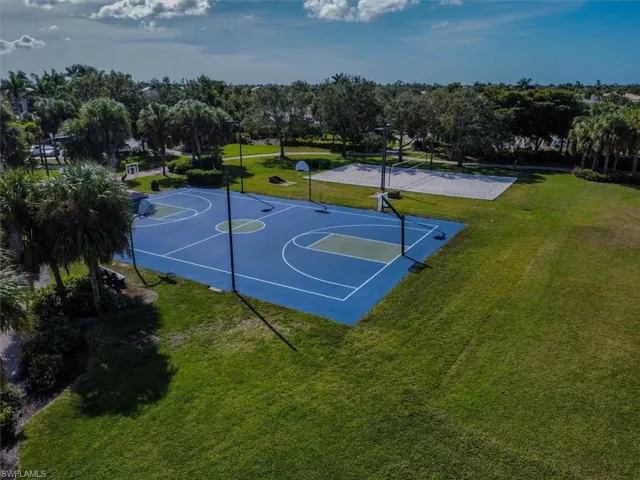 View of basketball court featuring a lawn and volleyball court