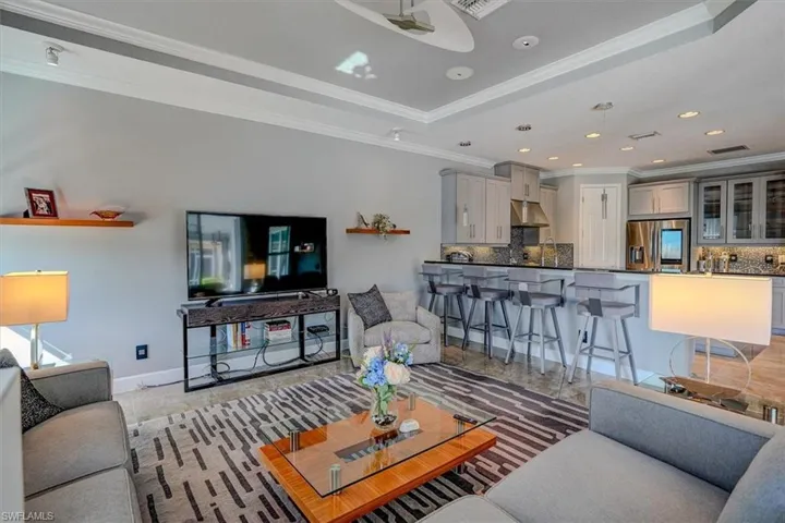 Family room featuring ornamental molding and a raised ceiling