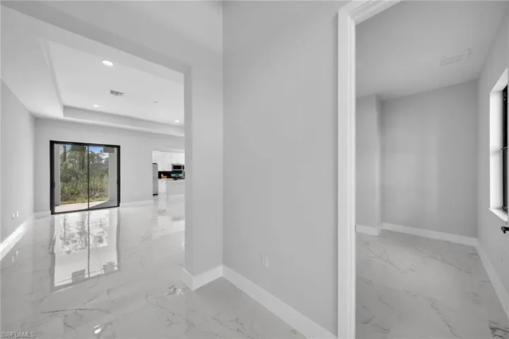 Corridor featuring a tray ceiling