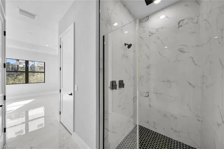 Bathroom featuring tiled shower