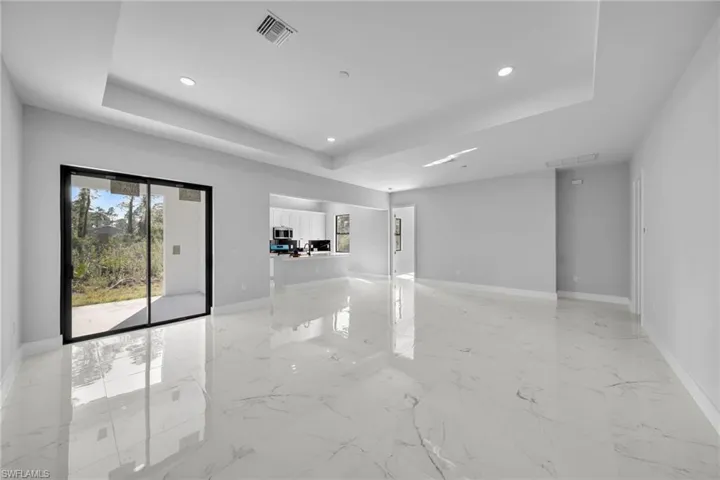 Empty room featuring a tray ceiling