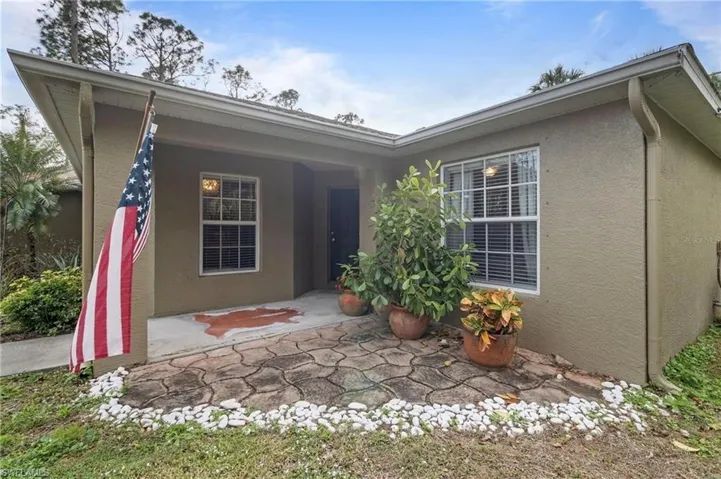 Entrance to property with a patio area and stucco siding
