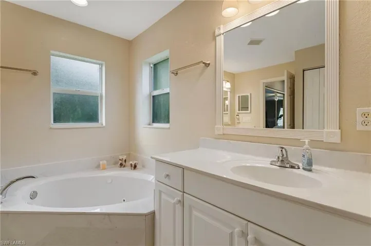 Bathroom with vanity and a bath
