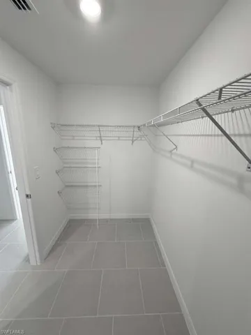 Walk in closet featuring light tile patterned floors