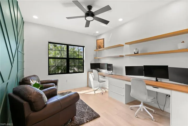 Office with recessed lighting, built in study area, and a ceiling fan