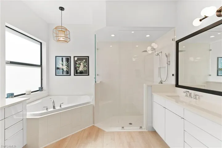 Bathroom featuring a tile shower, a garden tub, vanity, recessed lighting, and wood finished floors