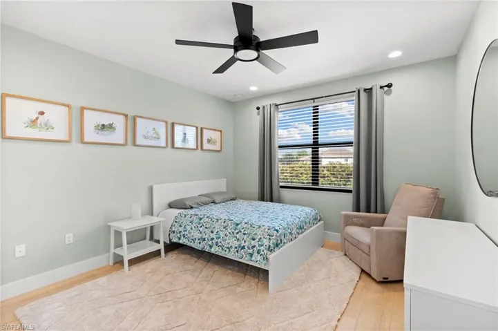Bedroom featuring baseboards, light wood finished floors, recessed lighting, and a ceiling fan