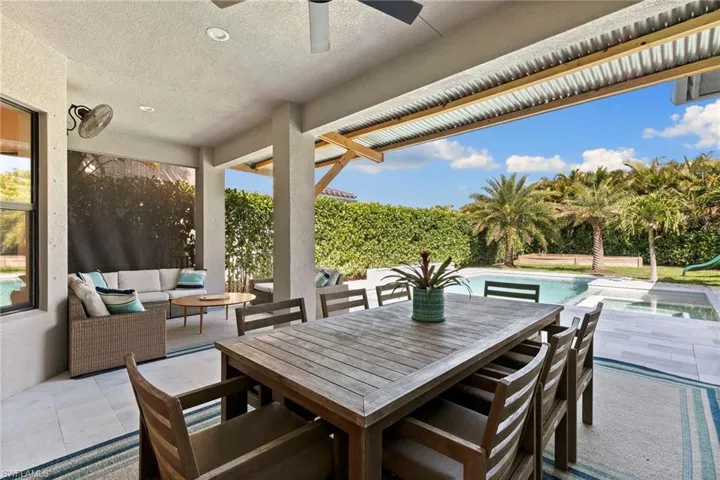 View of patio with an outdoor living space, an outdoor pool, outdoor dining space, and ceiling fan