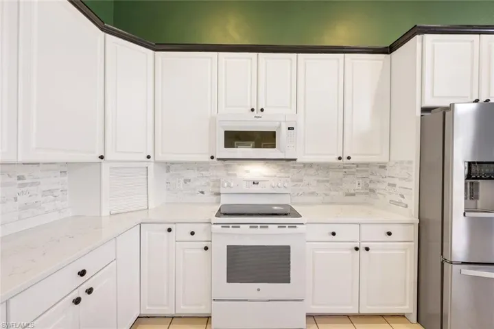 Kitchen features quartz countertops and plenty of storage!