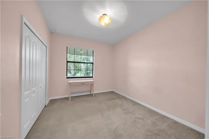 Wall-to-wall carpeting and a ceiling-mounted light fixture