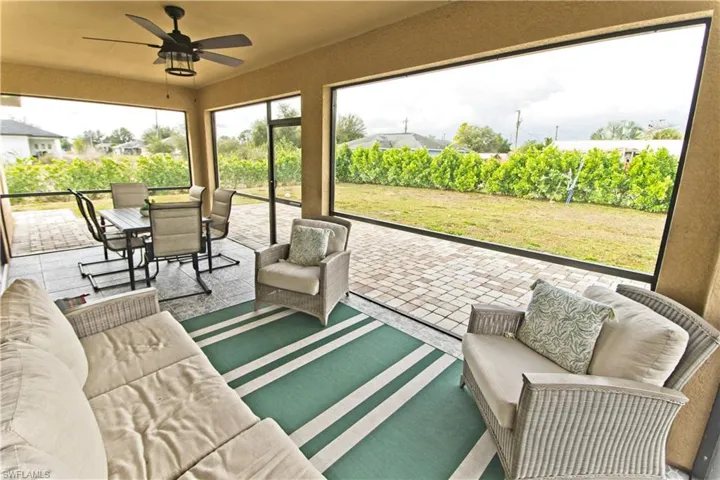 Sunroom with an outdoor living space, a ceiling fan, and outdoor dining space