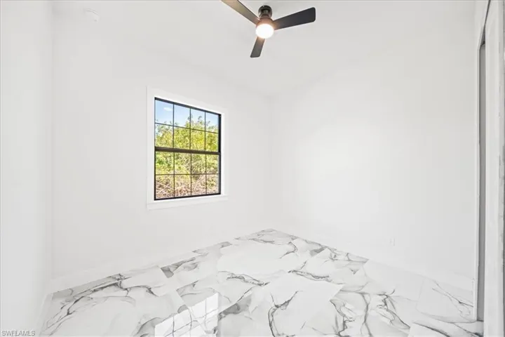 Unfurnished bedroom with baseboards and a ceiling fan