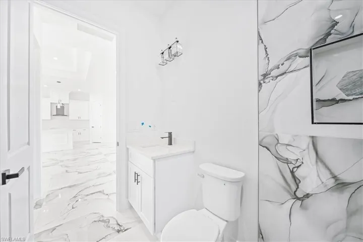 Bathroom featuring vanity and light marble finish floors