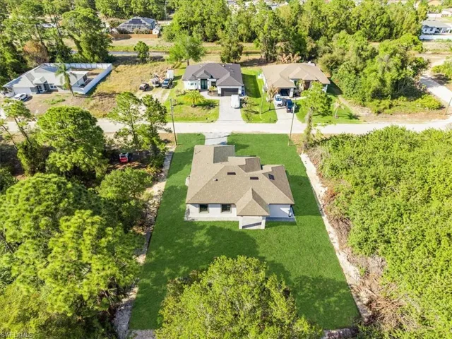 Aerial view of residential area featuring a tree filled landscape