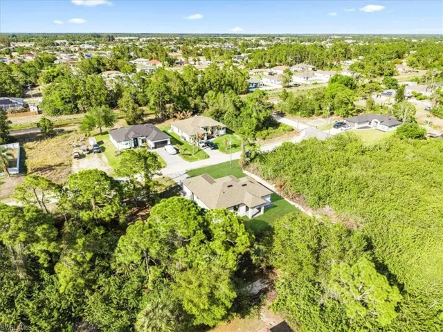 Aerial view of residential area featuring a tree filled landscape