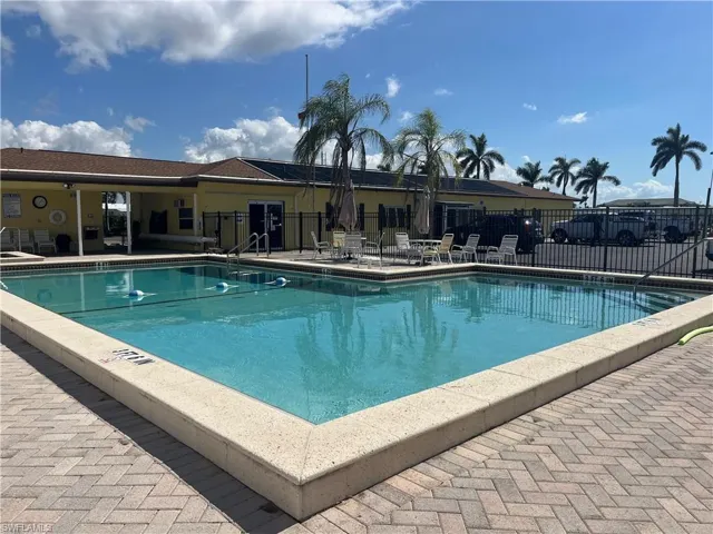 Community pool with a patio