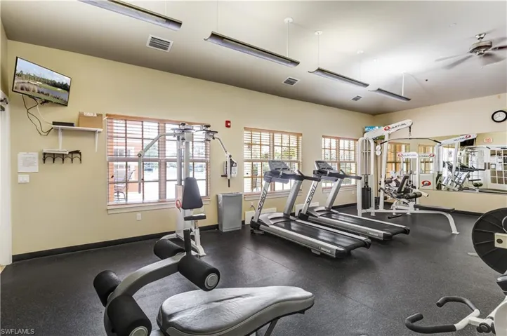 Rear view of property with stucco siding, a tile roof, a patio area, and a pergola