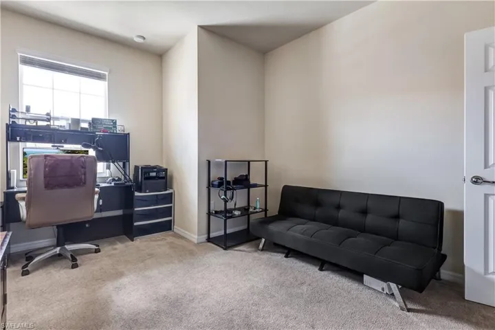 Carpeted home office with baseboards