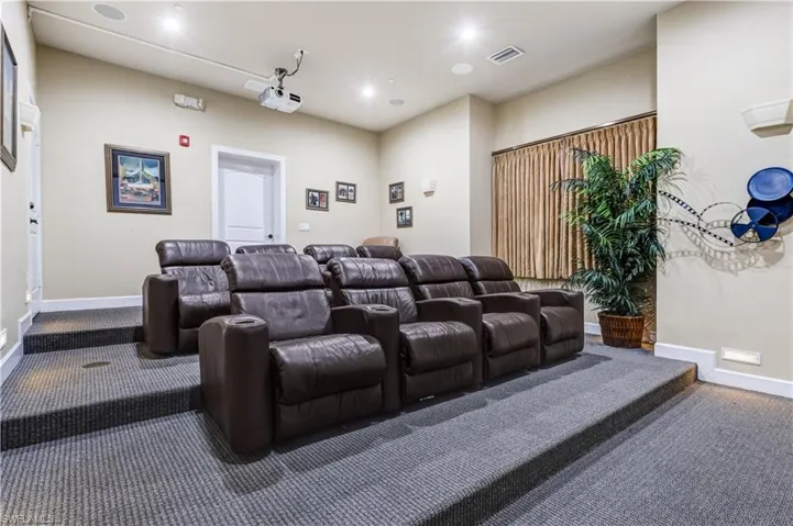 Carpeted home theater room featuring baseboards and recessed lighting