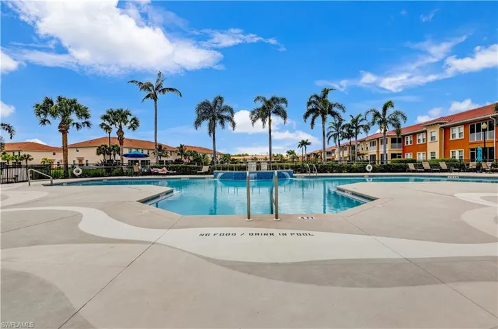 Community pool with a patio