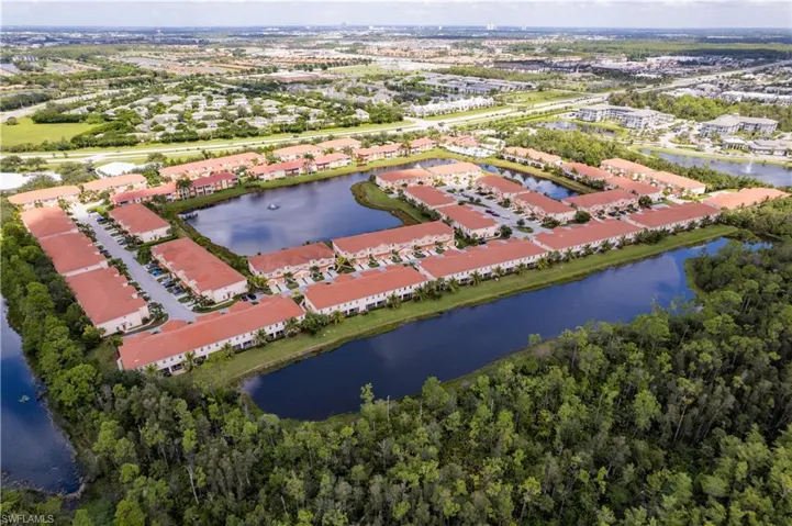 Aerial view of property's location with a forest and a nearby body of water
