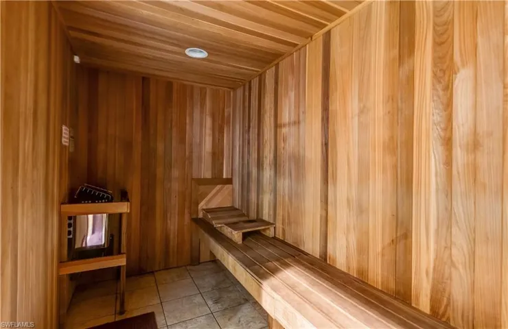 Workout area with a ceiling fan and lofted ceiling