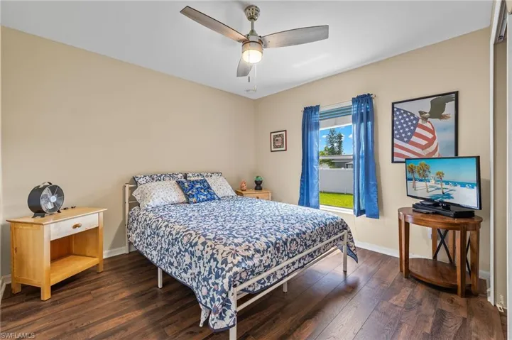 Bedroom with hardwood / wood-style floors and ceiling fan