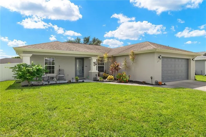 View of front of home featuring a garage and a front yard