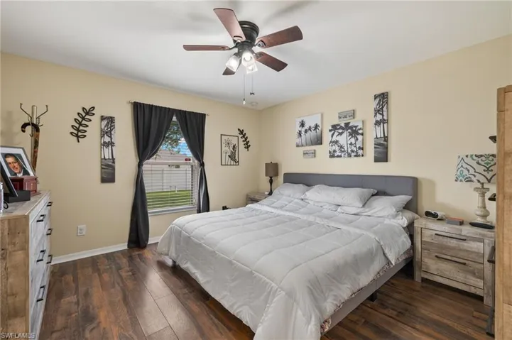 Bedroom with ceiling fan and dark hardwood / wood-style flooring