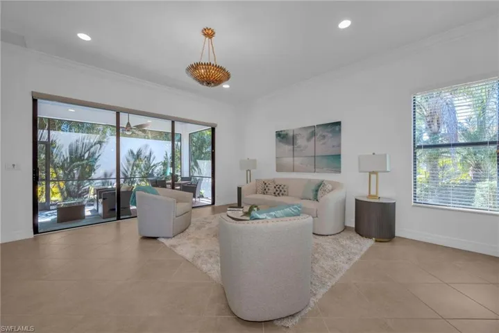 Bright open-concept living area with large windows and seamless indoor-outdoor flow.