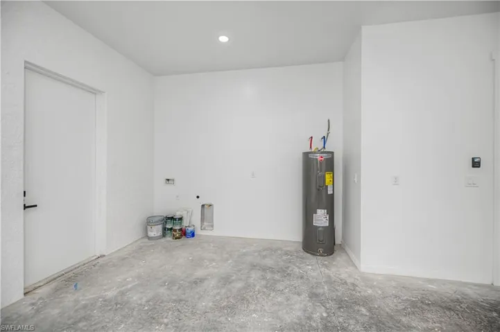 Garage with electric water heater and recessed lighting