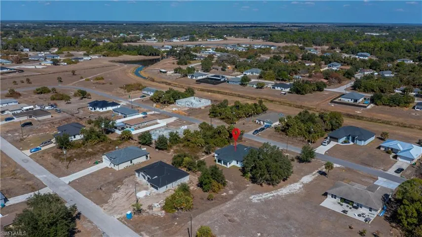 Aerial view of property's location featuring nearby suburban area