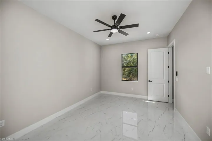 Unfurnished room featuring light marble finish floors, recessed lighting, and a ceiling fan