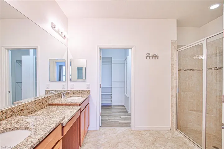 Primary Bathroom; dual sinks, oversized tiled shower w/built-in bench