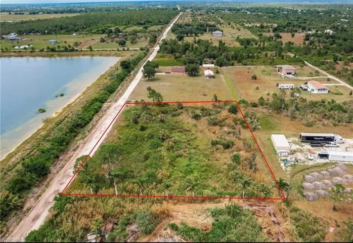 View of rural area featuring property boundaries highlighted and a nearby body of water