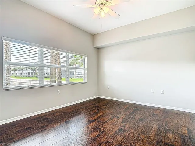 Spare room with ceiling fan and dark wood finished floors