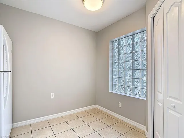Empty room featuring light tile patterned flooring
