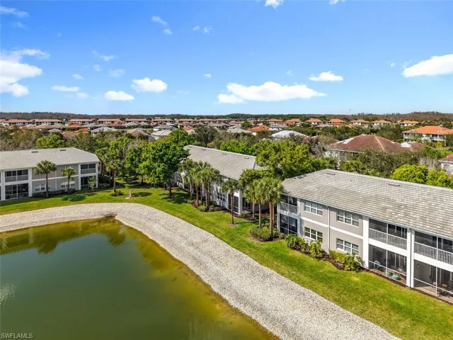 Aerial view of a large body of water and apartment complex / building