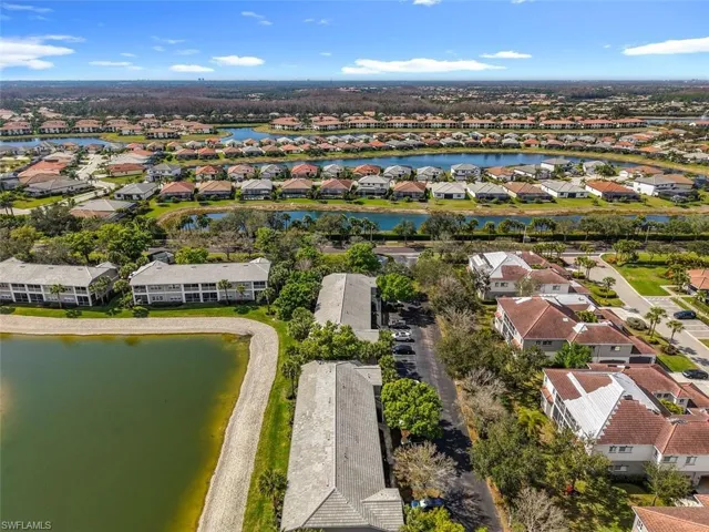 Aerial perspective of suburban area featuring a large body of water