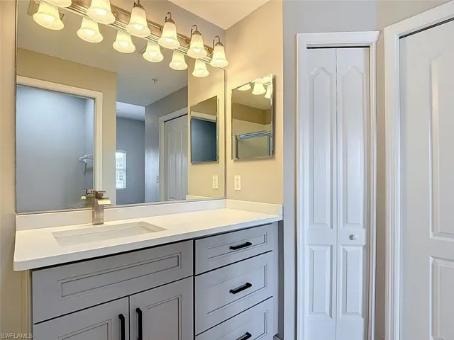 Bathroom with a closet and vanity