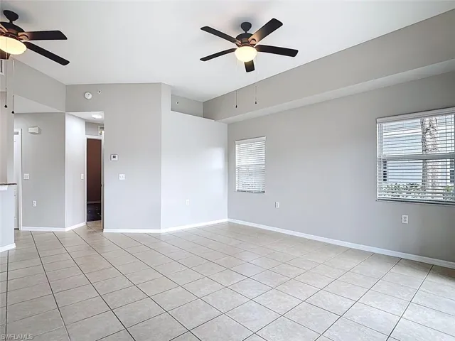 Spare room with ceiling fan and light tile patterned floors
