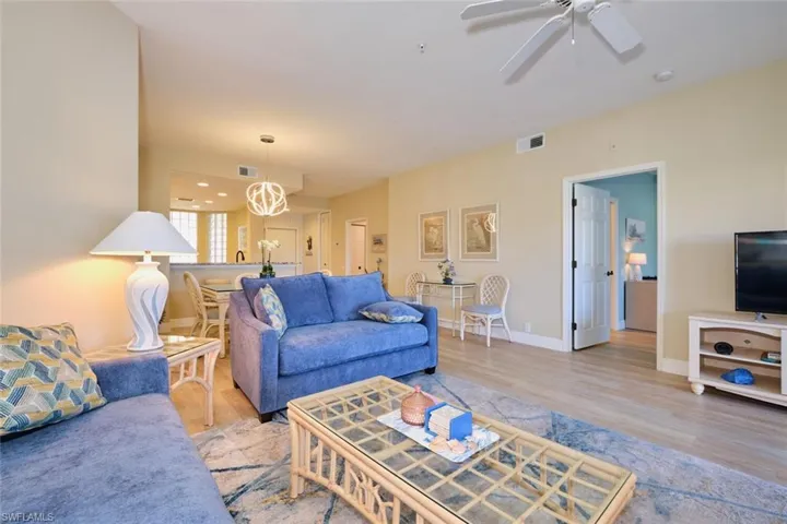 Living room featuring ceiling fan and light hardwood / wood-style floors