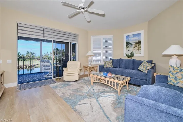 Living room featuring wood-type flooring and ceiling fan