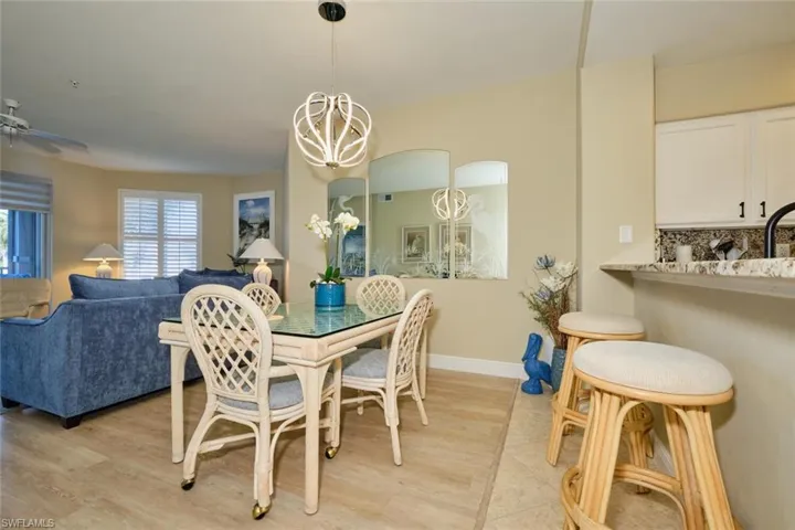 Dining room featuring ceiling fan with notable chandelier and light hardwood / wood-style flooring
