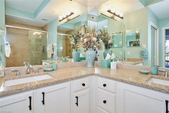Bathroom featuring vanity and an enclosed shower