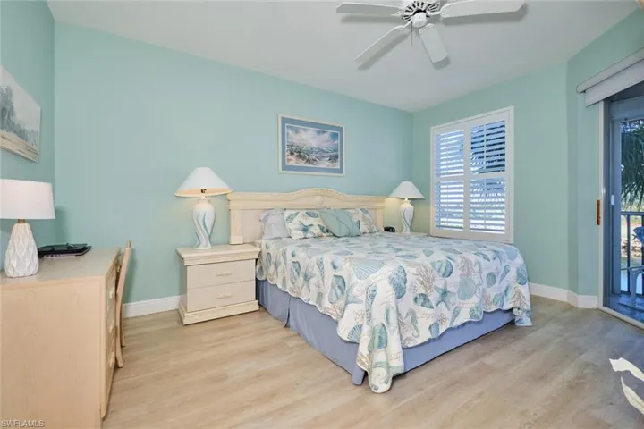 Bedroom with access to exterior, ceiling fan, and light hardwood / wood-style floors
