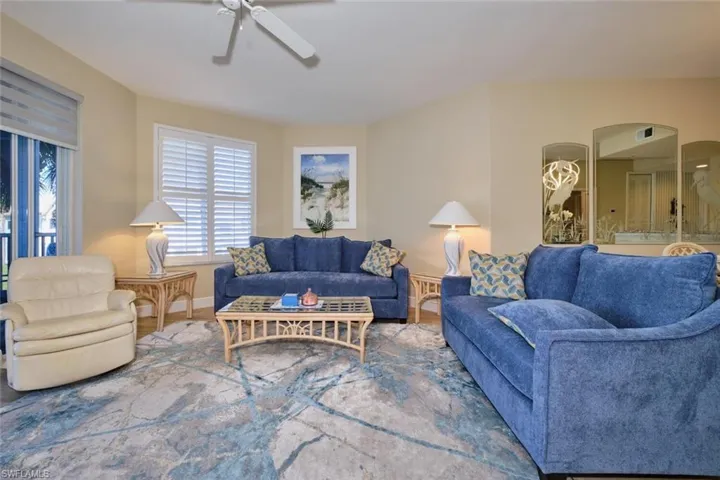 Living room with hardwood / wood-style flooring and ceiling fan