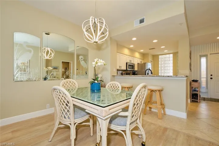 Dining room with light wood-type flooring and a chandelier