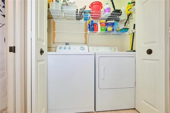 Laundry area featuring tile patterned floors and independent washer and dryer