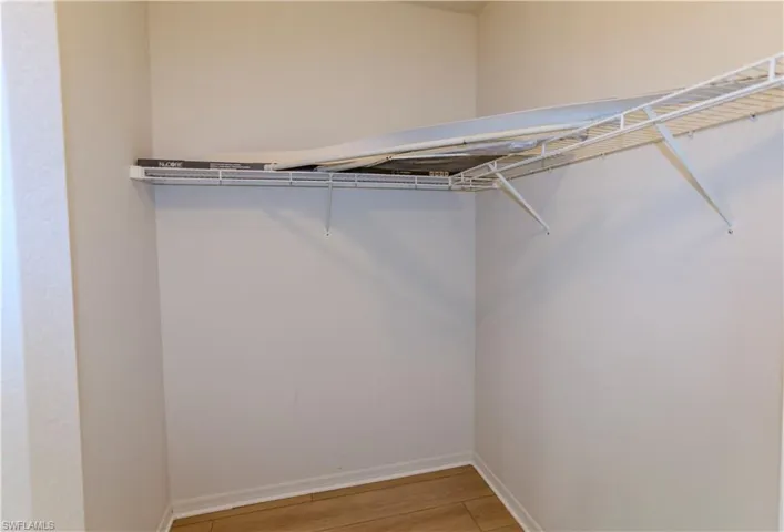 Spacious closet with light wood finished floors